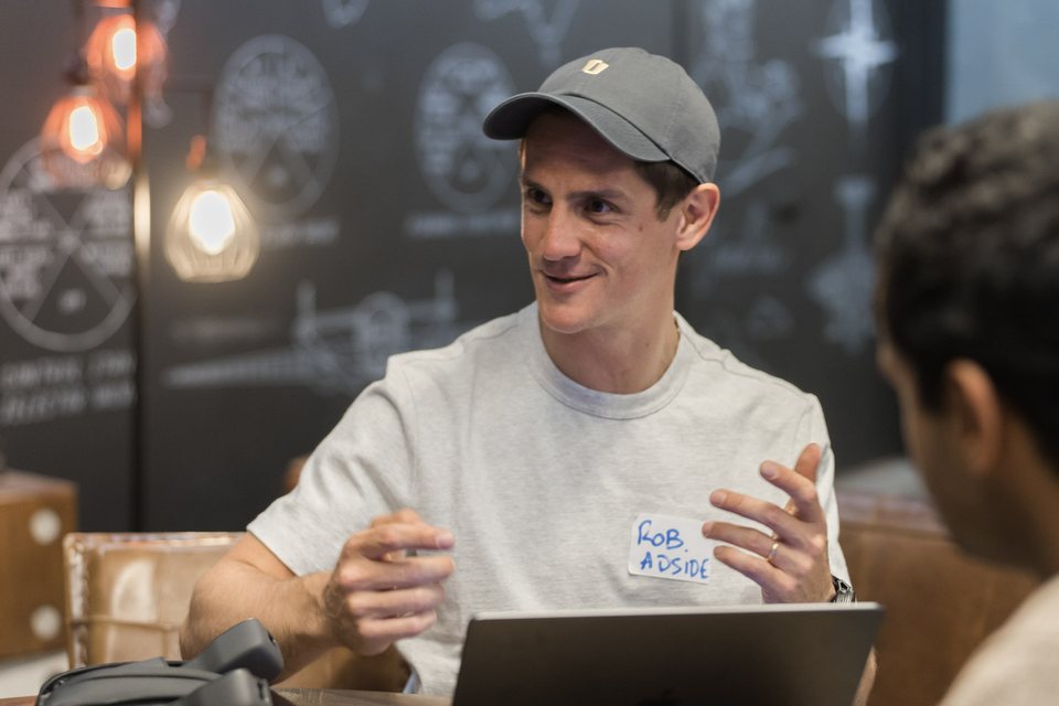Robin Choy talking with a founder at an Adside workshop